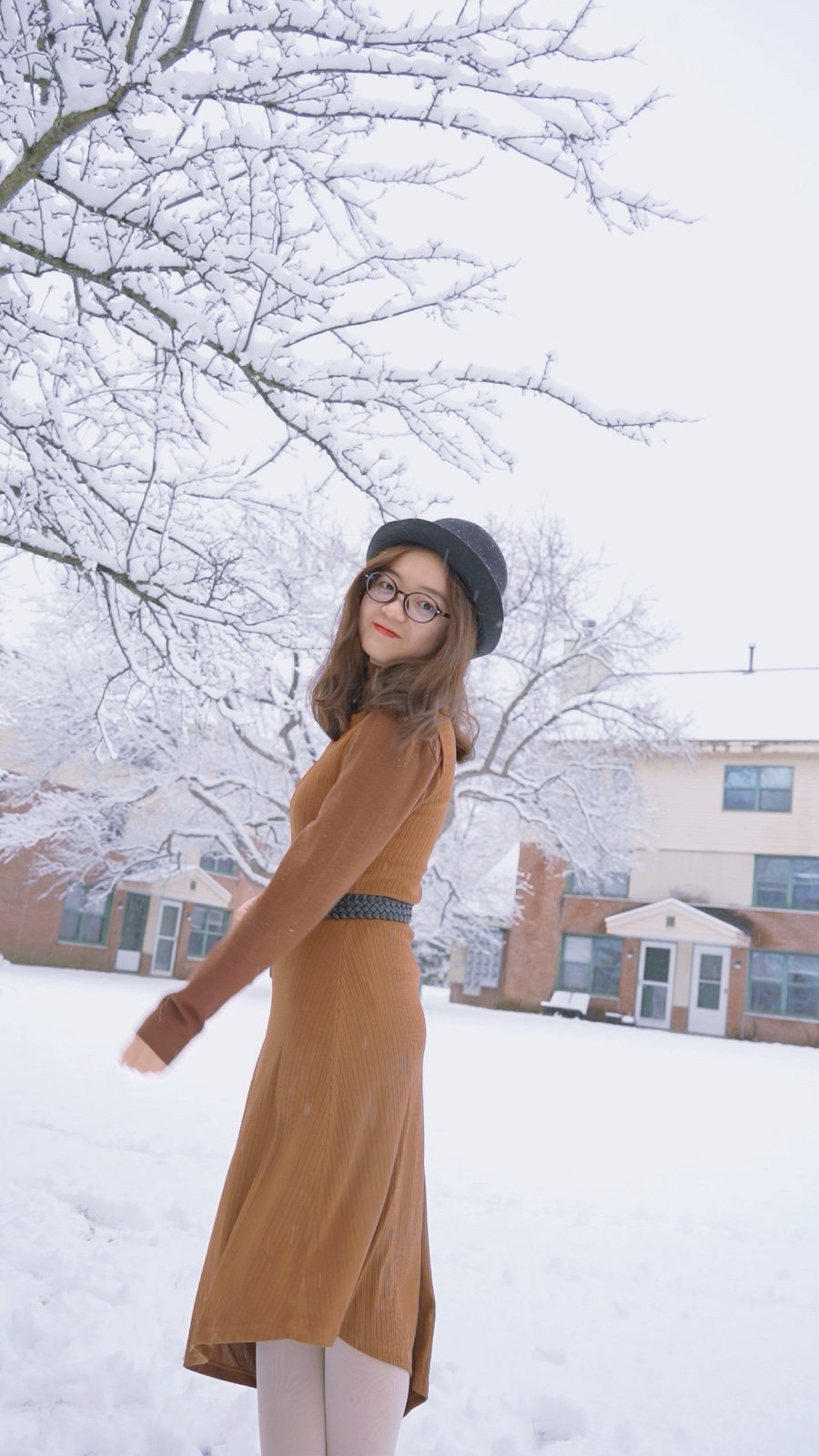 Lulu Zhao beneath snow-covered trees in winter