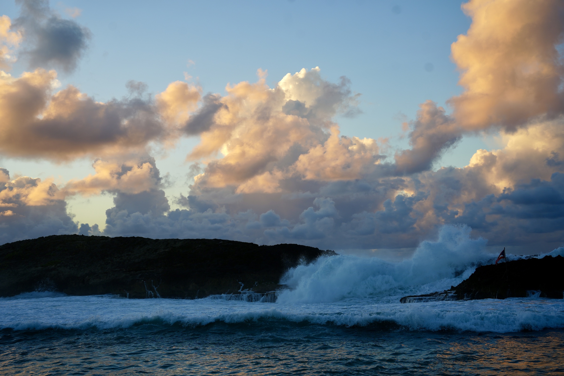 Ocean waves beneath warm evening clouds in Puerto Rico